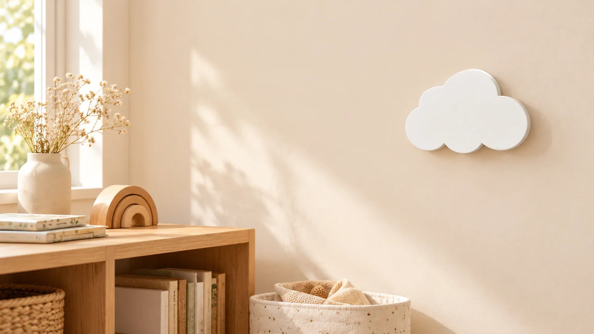 Patère blanche en forme de nuage sur un mur de chambre avec panier de rangement