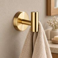 Patère design dorée en inox à vis : petite serviette suspendue